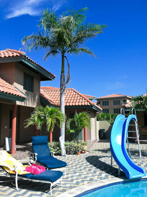 Aruba poolside with lounge chairs and slide