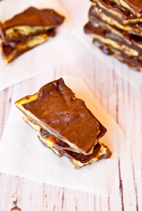 stacks of saltine toffee on parchment paper squares