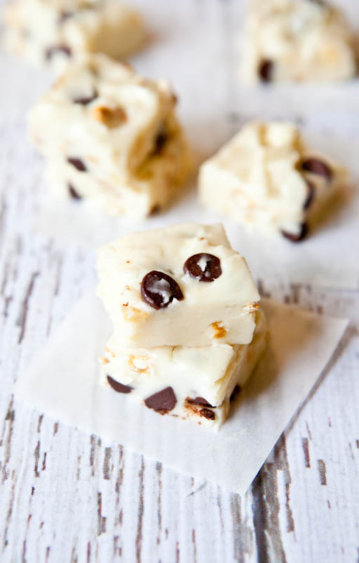 White Chocolate Peanut, Pretzel, and Chocolate Chip Fudge stacked on parchment paper