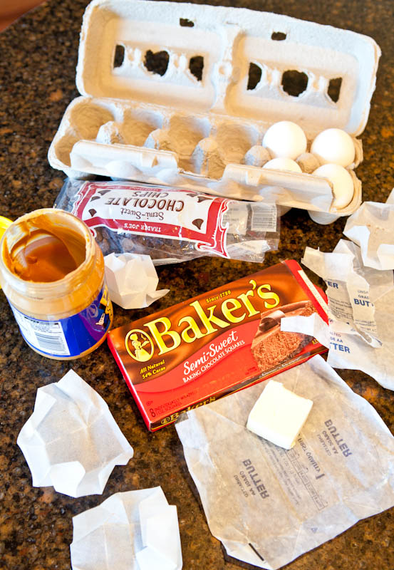 ingredients for baking laid out, eggs, chocolate, peanut butter