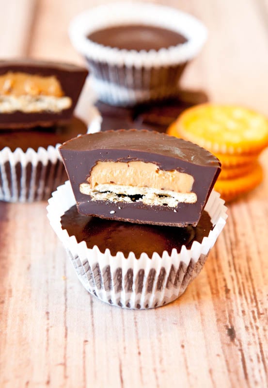 Two stacked Ritz Cracker Stuffed Peanut Butter Cups with one cut open