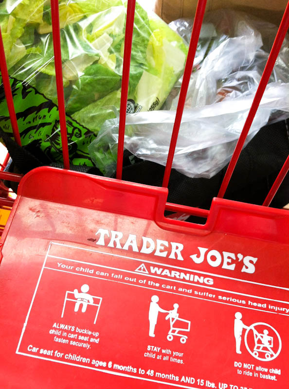 trader joe's shopping cart with bag of lettuce