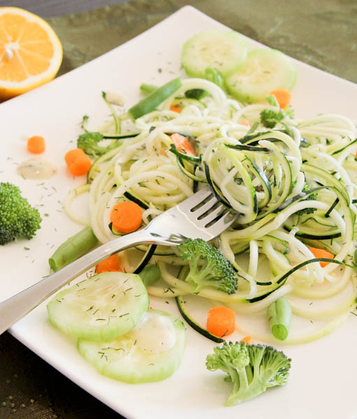 Raw pasta salad with lemon and herb dressing and vegetables