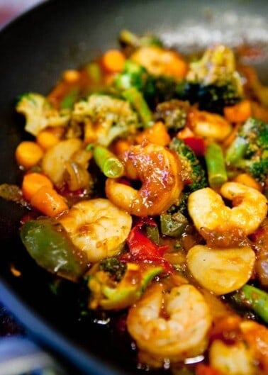 Stir-fried shrimp and mixed vegetables in a sauce.
