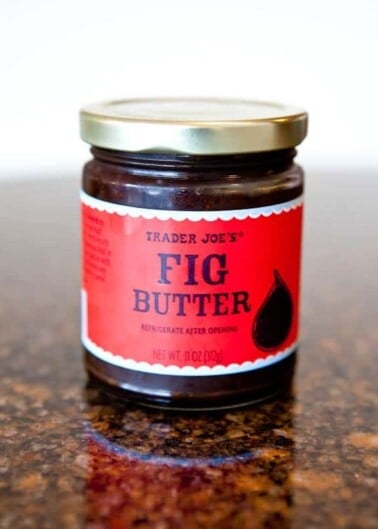 A jar of trader joe's fig butter on a countertop.