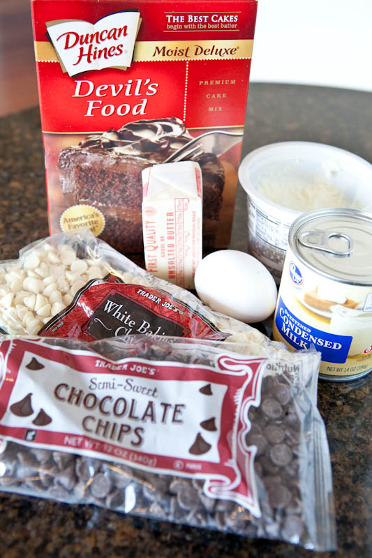 Kitchen counter spread of devil's food cake mix and chocolate chips with other ingredients