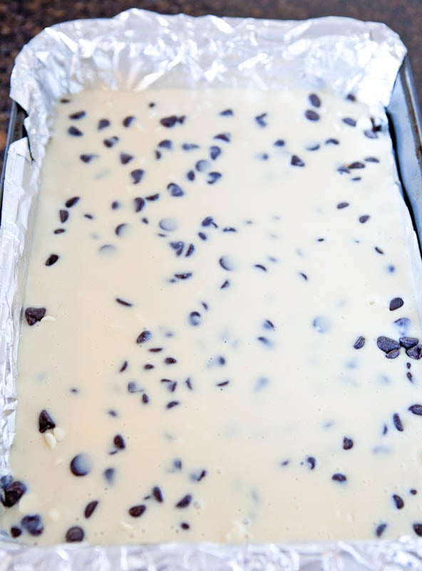 Pre-baking White and Dark Chocolate Cream Cheese Chocolate Cake Bars flooded with condensed milk