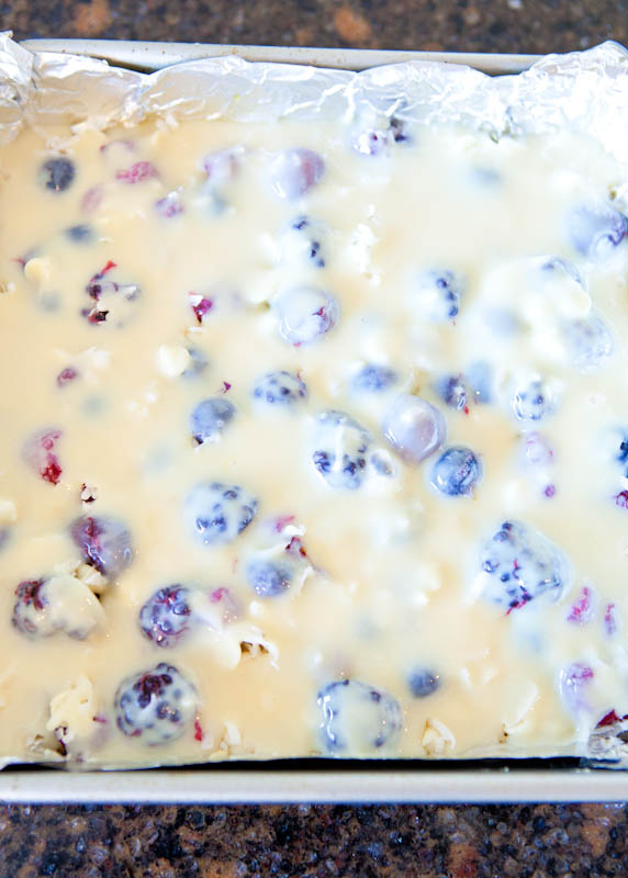 Pre-baking Creamy Mixed Berry White Chocolate Crumble Bars flooded with ingredients