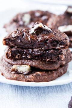 Mounds Bar Chocolate Coconut Cake Mix Cookies staked on white plate with one split open