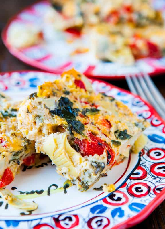 Spinach Artichoke and Roasted Red Pepper Cheesy Squares on colorful plate