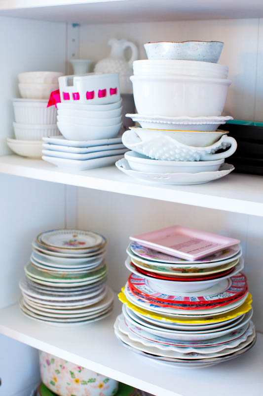 Plates and bowls stacked inside shelves
