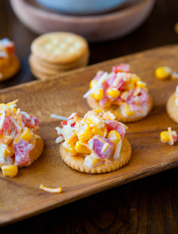 Corn and Double Cheese Dip on crackers on wood