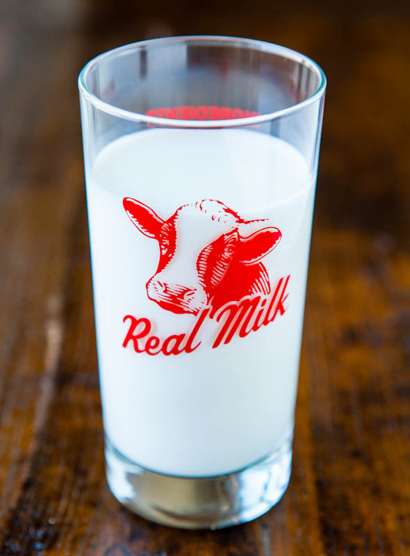 milk in glass with cow picture and real milk slogan