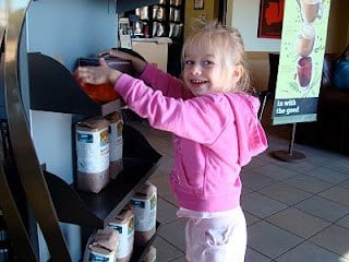 Young girl touching display at Starbucks