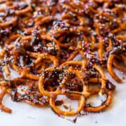 Pretzels drizzled with chocolate and topped with colorful sprinkles.