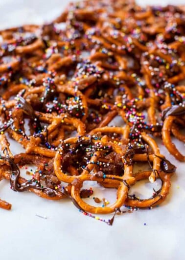 Pretzels drizzled with chocolate and topped with colorful sprinkles.