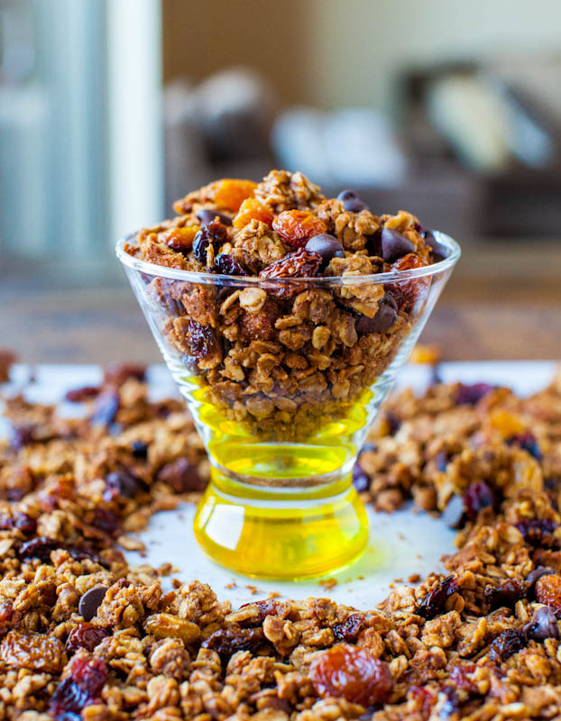 Pumpkin Spice Peanut Butter and Chocolate Chip Granola in clear dish surrounded by more granola