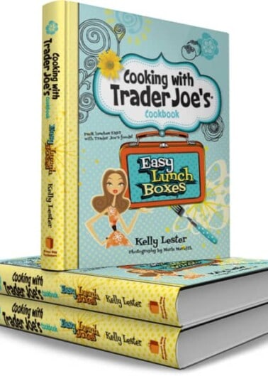 Three stacked cookbooks titled "cooking with trader joe's cookbook," with the top book titled "easy lunch boxes.