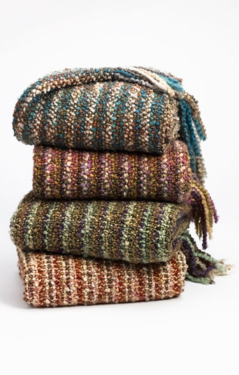 Stack of chunky red and green throw blankets