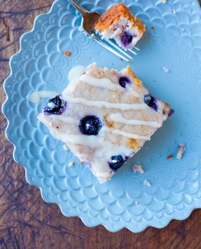 Blueberry Yogurt Cake with Lemon Vanilla Glaze on blue plate