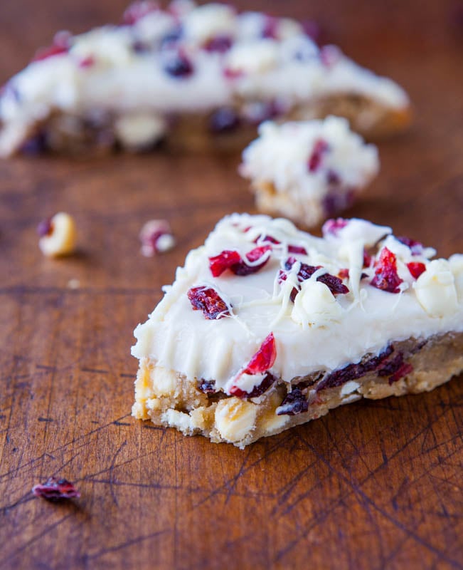 close up view of a cranberry bliss bar with a bite missing 