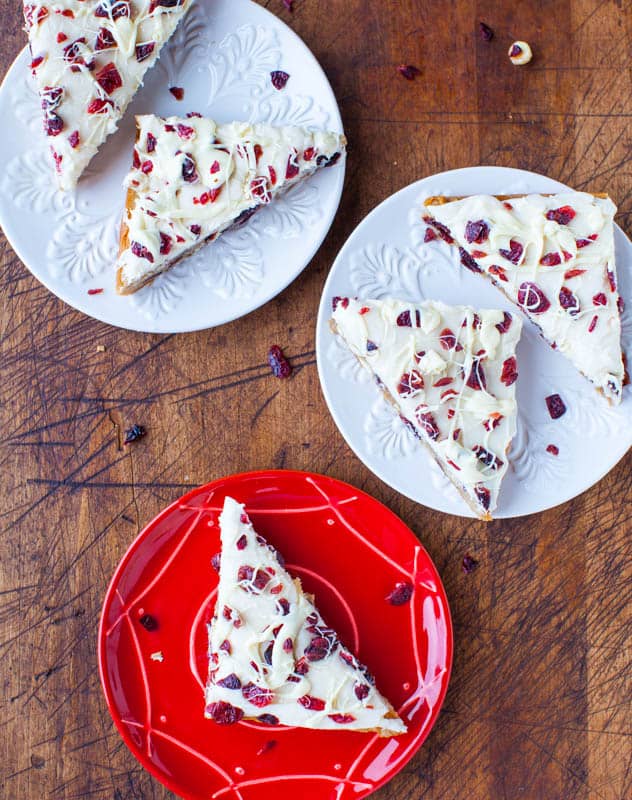 Overhead shot of Cranberry Bliss Bars (Starbucks Copycat) on red and white plates