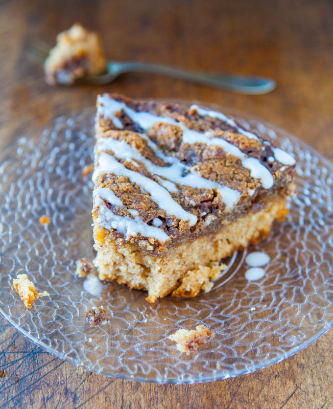 slice of cinnamon roll coffee cake on a glass plate with a bite missing 