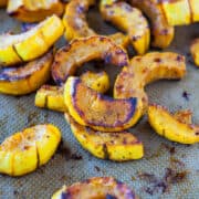 Roasted squash slices on a baking sheet.