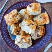 A bowl of freshly baked scones on a table.