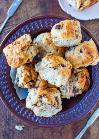A bowl of freshly baked scones on a table.