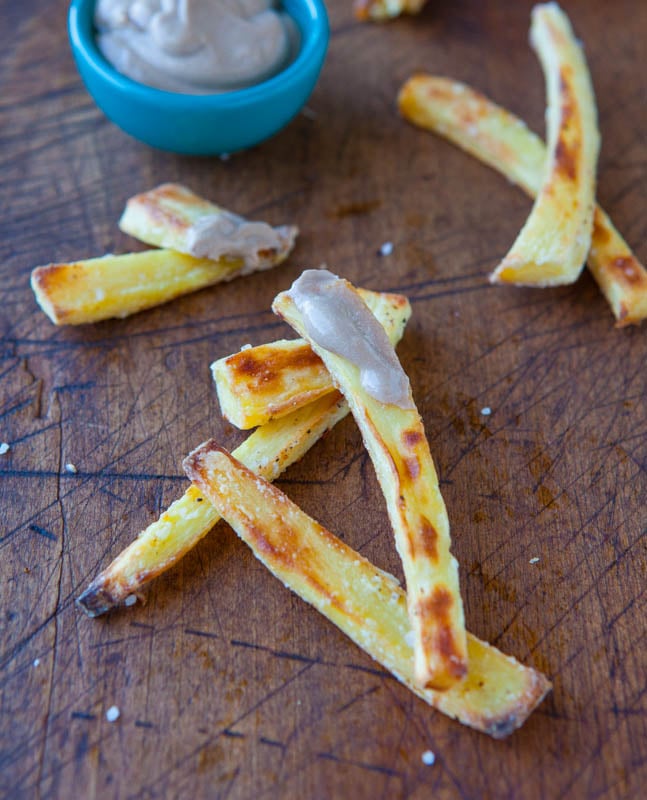 Baked Parsnip Fries with Creamy Balsamic Reduction Dip on them