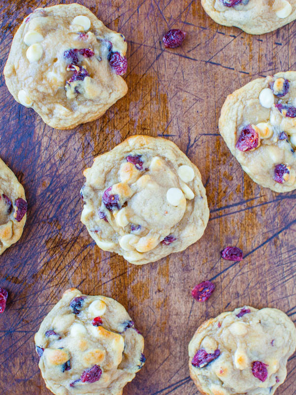 overhead view of cranberry white chocolate chip cookies on a wood surface 