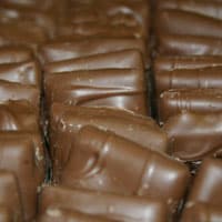 Rows of milk chocolate candies with a ridged pattern.