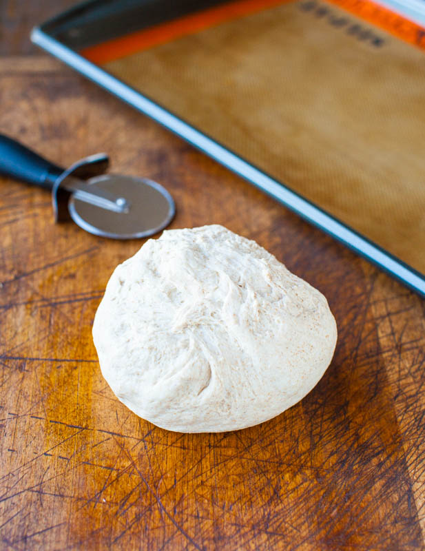 1-Hour Whole Wheat Pizza Dough — The dough is soft, chewy, thick and hearty, versatile, and EASY! Simply combine all ingredients in a mixing bowl, knead for about 8 minutes, wait an hour, and bake it off! 