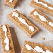 Homemade cereal bars with a drizzle of white icing on top.