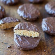 Chocolate-covered biscuits with one bisected to show the inner filling.