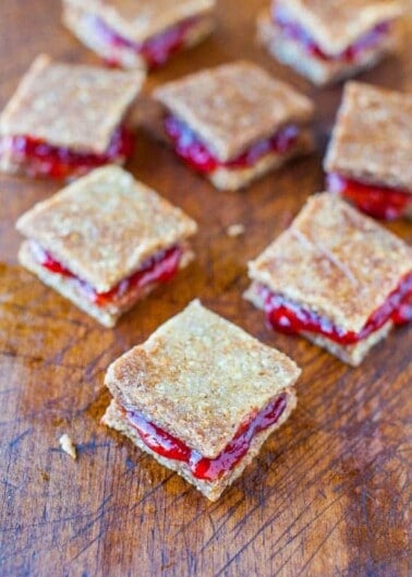 Homemade strawberry jam sandwiched between layers of pie crust on a wooden surface.