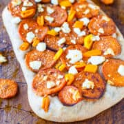 A flatbread pizza topped with sliced sweet potatoes, cheese, and bell peppers.