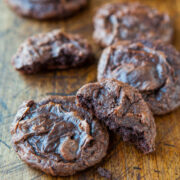 Freshly baked chocolate cookies on a wooden surface.