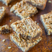 Homemade cereal bars on a wooden cutting board.