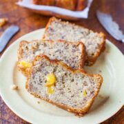 Slices of banana bread with visible banana chunks on a plate.