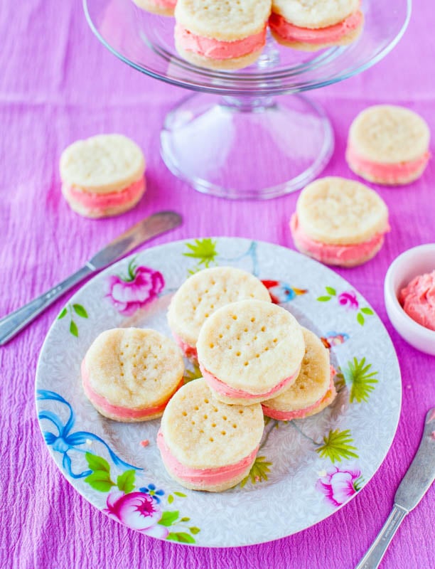 frosted wafer cookies on a floral plate and on a glass cake stand 