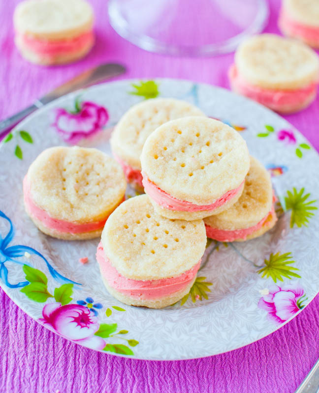 sugar wafer cookies sandwiched with pink buttercream on a floral plate. 