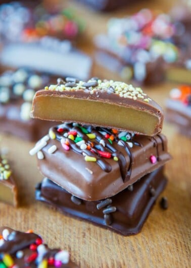 A stack of chocolate-covered caramels topped with sprinkles.