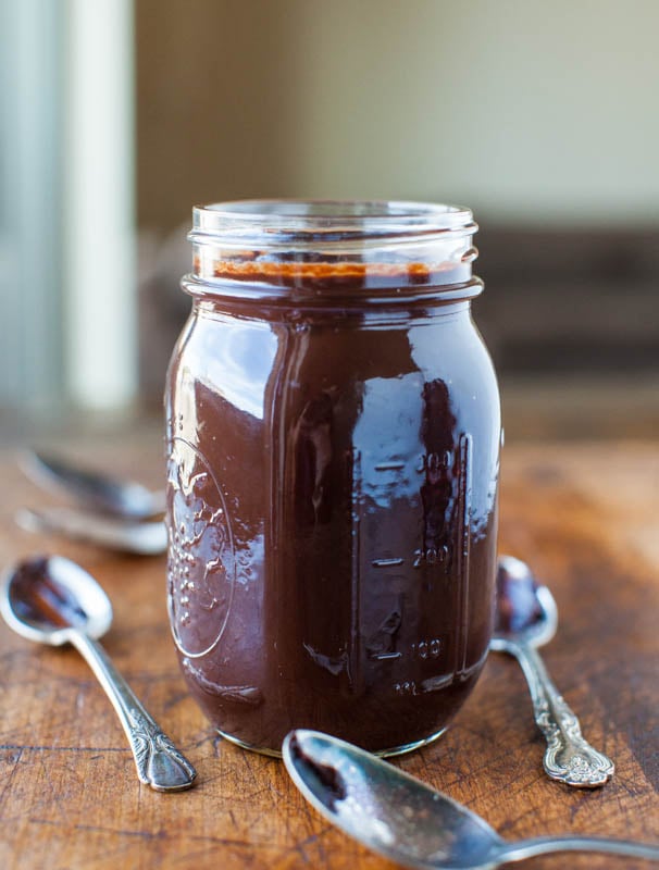 hot fudge in glass jar with spoons