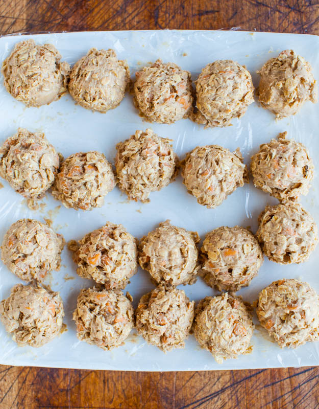 overhead view of oatmeal scotchies cookie dough balls on parchment paper 