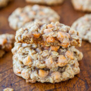 A stack of oatmeal cookies with butterscotch chips on a wooden surface.