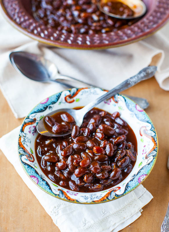 small dish of bourbon baked beans in front of larger dish of beans