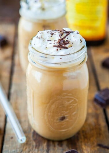 Iced coffee with whipped cream and chocolate shavings served in a mason jar.