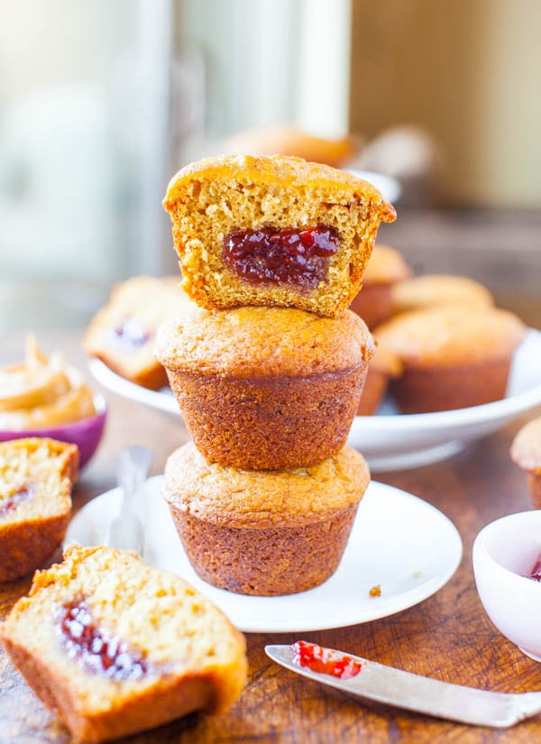 Stacked Peanut Butter and Jelly Muffins with one muffin in half showing jelly center